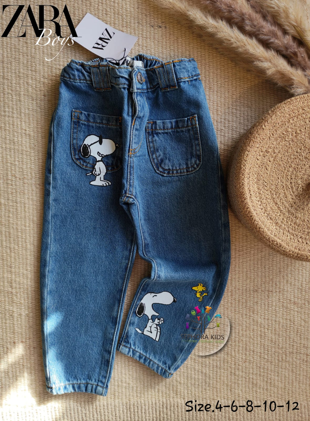 Blue jeans with Snoopy designs on a textured surface