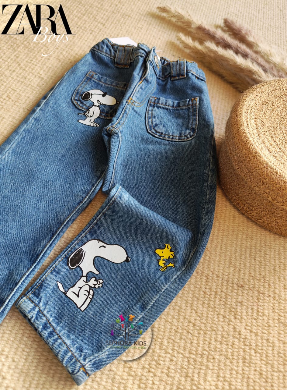 Blue jeans with Snoopy designs on a textured surface