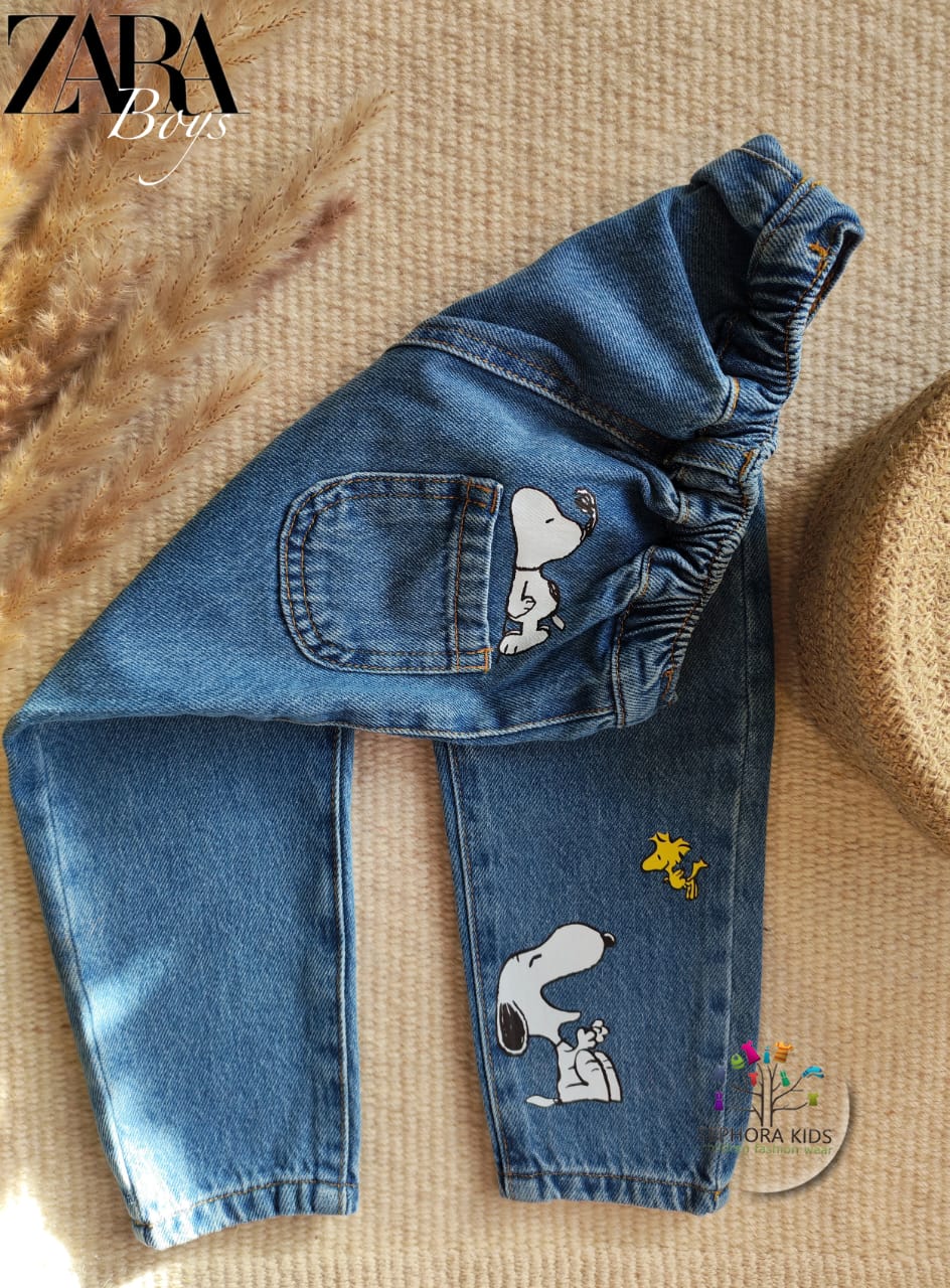Blue jeans with Snoopy designs on a textured surface