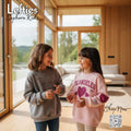 Two children wearing branded sweatshirts in a modern living room with 'Lefties Sephora Kids' branding.